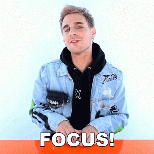 A Man Wearing A Denim Jacket And A Black Hoodie With The Word Focus Written On It GIF