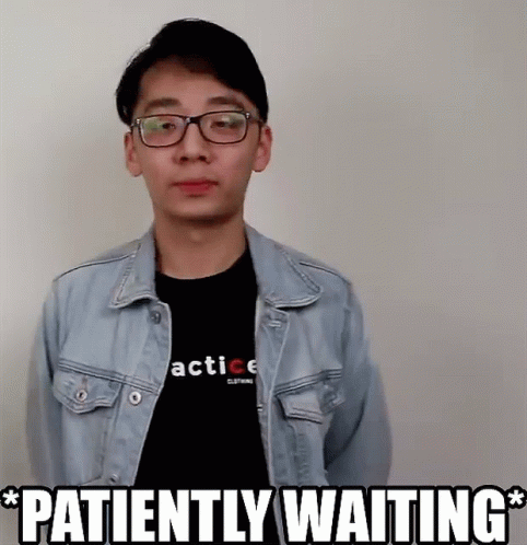 A Man Wearing A Denim Jacket And A Black Shirt With The Words Patiently Waiting GIF
