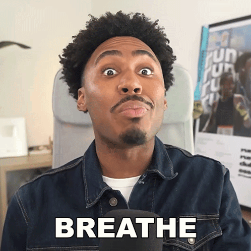 A Man Wearing A Denim Jacket Says Breathe GIF
