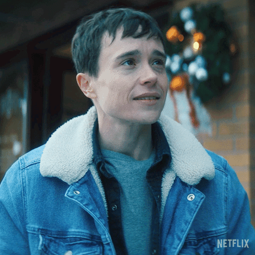 A Man Wearing A Denim Jacket With A Sherpa Collar And A Netflix Logo On The Bottom GIF