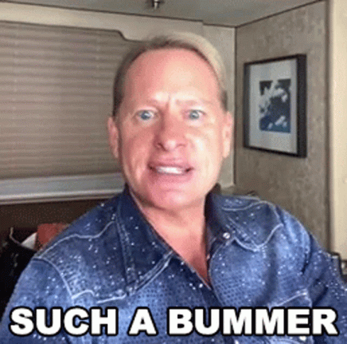 A Man Wearing A Denim Shirt Is Making A Funny Face And Says Such A Bummer . GIF