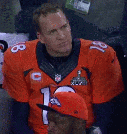 a man wearing a denver broncos jersey with the number 18 on it