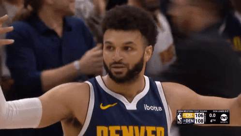 A Man Wearing A Denver Jersey Stands In Front Of The Crowd GIF