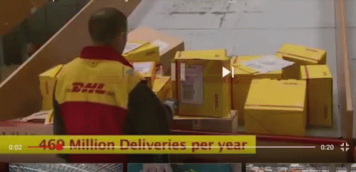 A Man Wearing A Dhl Jacket Is Standing In Front Of A Bunch Of Boxes GIF