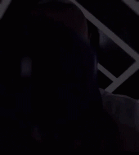 a man wearing a dodgers jersey is covering his face