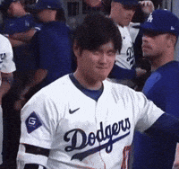 A Man Wearing A Dodgers Jersey Stands In A Dugout GIF