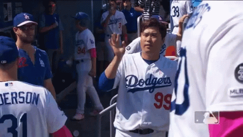 A Man Wearing A Dodgers Jersey Waves To A Fan GIF