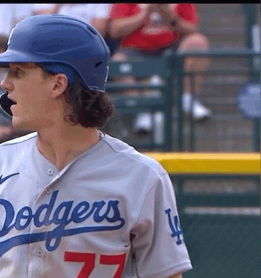 A Man Wearing A Dodgers Jersey With The Number 77 GIF