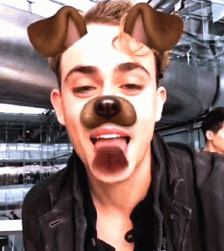 A Man Wearing A Dog Mask With His Tongue Sticking Out GIF