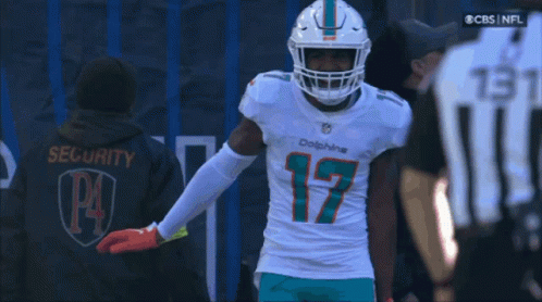 A Man Wearing A Dolphins Jersey With The Number 17 On The Front GIF
