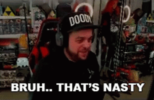 A Man Wearing A Doom Hat And Headphones Is Sitting In A Chair In A Room . GIF