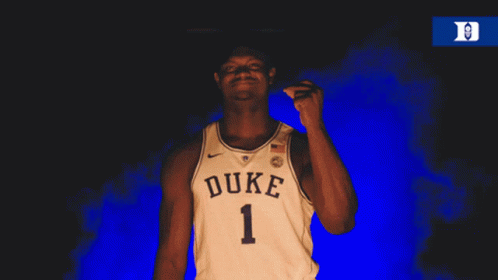 A Man Wearing A Duke Jersey Is Pointing His Finger GIF