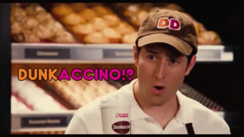 A Man Wearing A Dunkin Donuts Hat Is Holding A Cup GIF