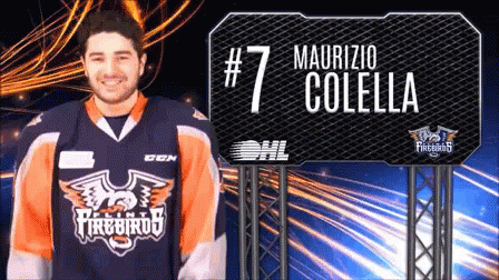 A Man Wearing A Firebirds Jersey Stands In Front Of A Sign That Says # 7 Maurizio Colella GIF