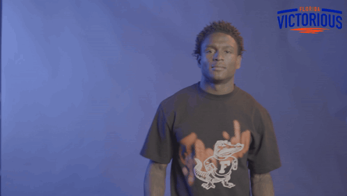 a man wearing a florida victorious shirt is dancing