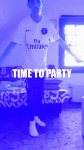 A Man Wearing A Fly Emirates Shirt Is Dancing In A Room GIF