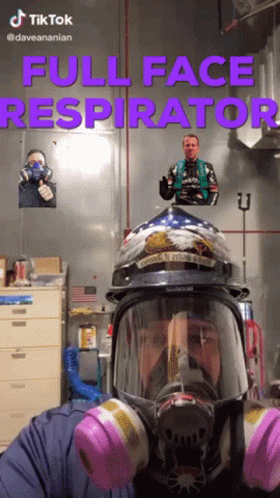 A Man Wearing A Full Face Respirator With A Helmet On GIF