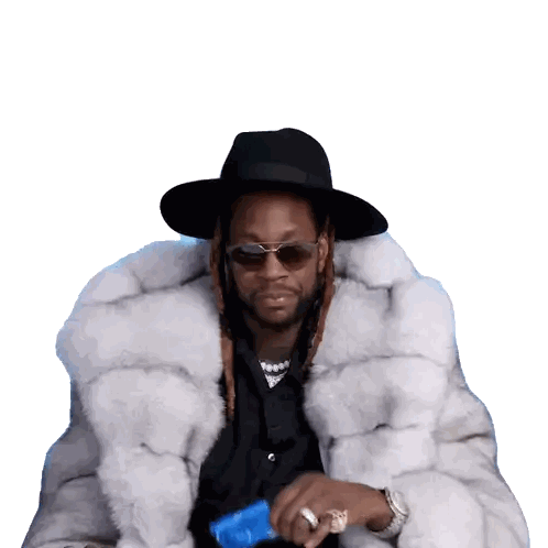 a man wearing a fur coat and a hat is holding a blue bottle