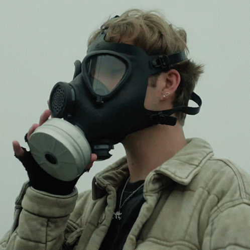 A Man Wearing A Gas Mask And Gloves GIF