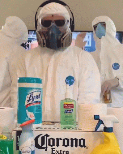 A Man Wearing A Gas Mask Is Standing Next To A Box Of Corona Extra GIF