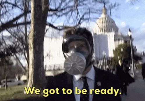 A Man Wearing A Gas Mask Says We Got To Be Ready In Front Of The Capitol Building GIF