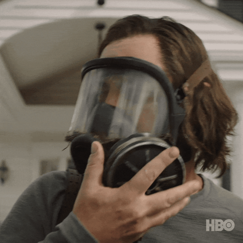 A Man Wearing A Gas Mask With Hbo Written On The Bottom Right GIF