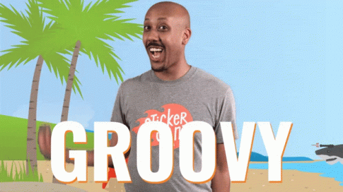 A Man Wearing A Gray Shirt That Says Groovy On It GIF