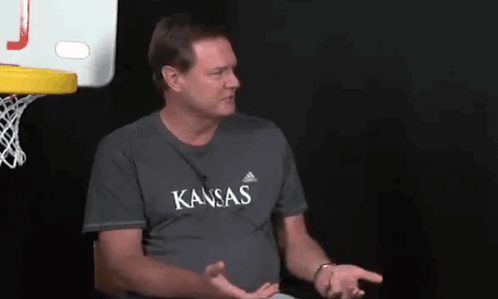 A Man Wearing A Gray Shirt That Says Kansas On It GIF