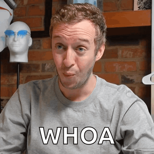 A Man Wearing A Gray Shirt That Says Whoa GIF