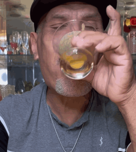 A Man Wearing A Gray Shirt With The Letter S On It GIF