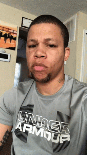 A Man Wearing A Gray Under Armour Shirt GIF