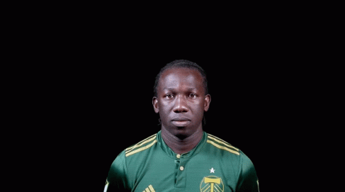 A Man Wearing A Green Adidas Shirt With A Star On It GIF