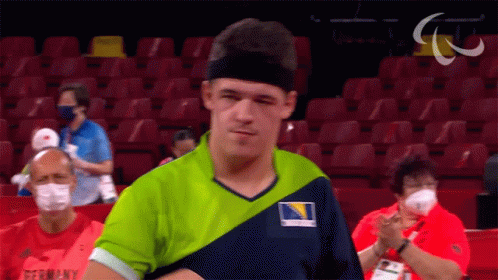 A Man Wearing A Green And Blue Shirt With Germany On The Front GIF