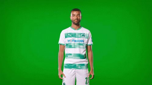 a man wearing a green and white hofmann shirt