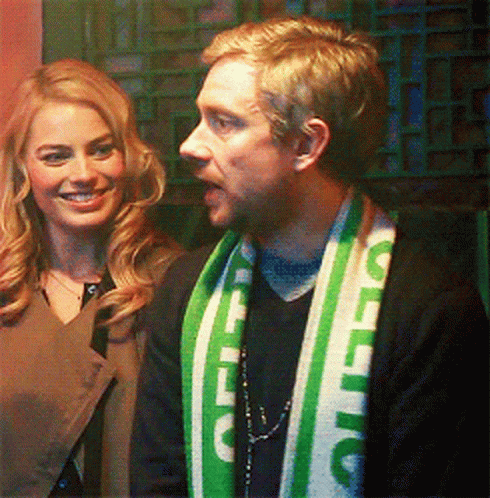 A Man Wearing A Green And White Scarf That Says Celtic On It GIF
