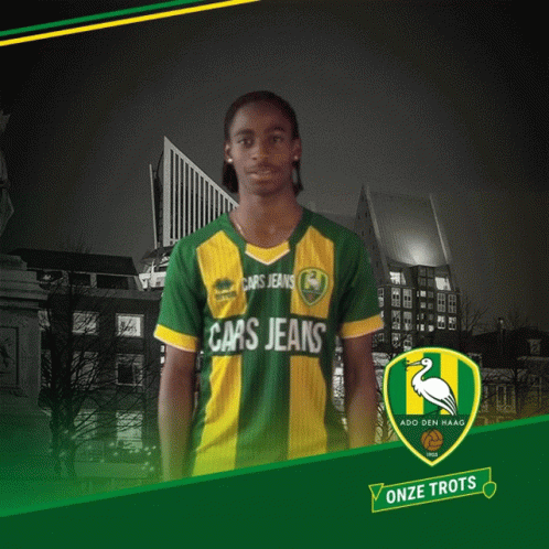 A Man Wearing A Green And Yellow Shirt That Says Cars Jeans On It GIF