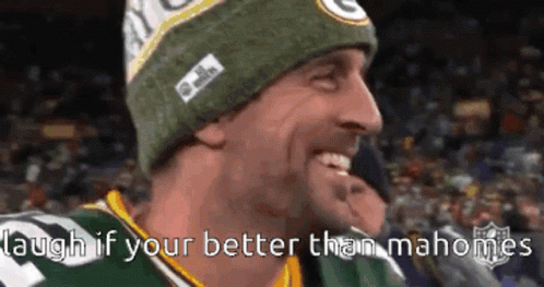 A Man Wearing A Green Bay Packers Hat Is Smiling And Laughing GIF