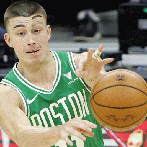 A Man Wearing A Green Boston Jersey Dribbles A Basketball GIF