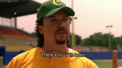 A Man Wearing A Green Hat And A Yellow Shirt Is Saying There 'S No I ' In Team . GIF