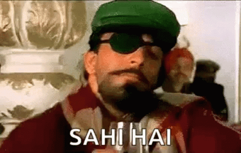 A Man Wearing A Green Hat And Sunglasses Is Smoking A Cigarette And Says Sahi Hai . GIF