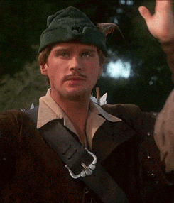 A Man Wearing A Green Hat With A S On It Holds His Head GIF