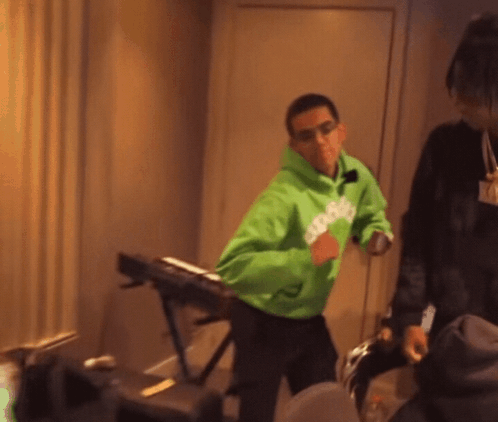 A Man Wearing A Green Hoodie That Says Snoop Dogg GIF