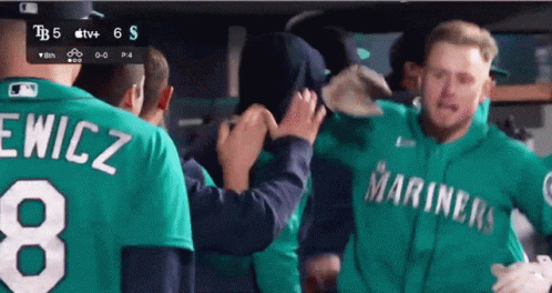A Man Wearing A Green Mariners Jersey With The Number 8 On It GIF