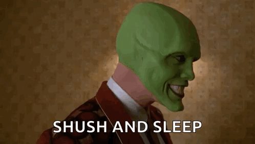 A Man Wearing A Green Mask Is Holding His Finger To His Mouth And Says Shush And Sleep . GIF