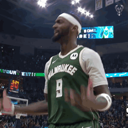 A Man Wearing A Green Milwaukee Jersey With The Number 9 GIF