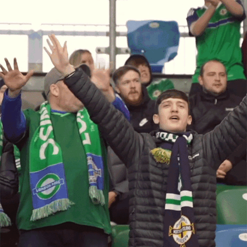 A Man Wearing A Green Scarf That Says Lsc On It GIF
