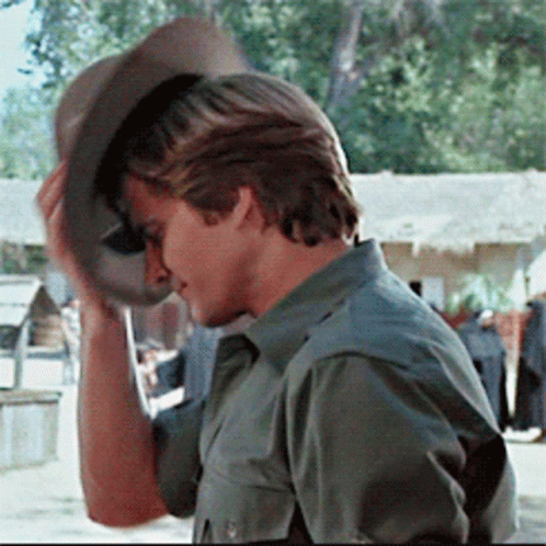 A Man Wearing A Green Shirt And A Cowboy Hat GIF