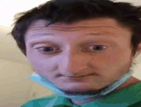 A Man Wearing A Green Shirt And A Face Mask GIF