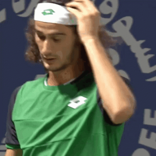 A Man Wearing A Green Shirt And A White Headband With A Lotto Logo On It GIF