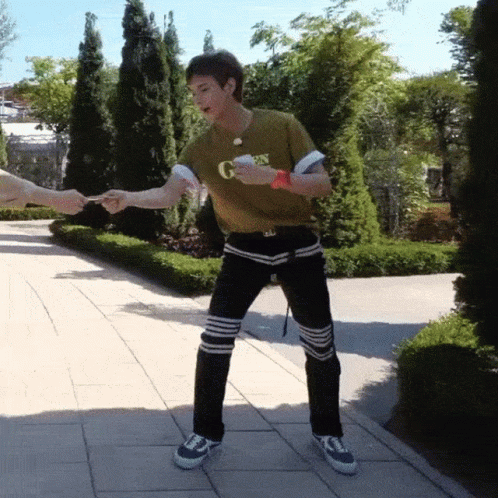 A Man Wearing A Green Shirt That Says G On It GIF
